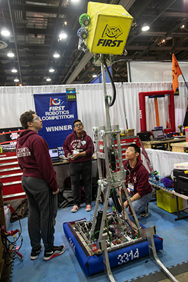 Members of the Mustangs test their robot in the team’s pit at the 2018 FIRST Championship in Houston.