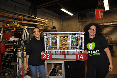 Sarai and Kim show the Mustang’s 2017 robot during a tour of the team’s build space.